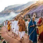 Pilgrims walking the Govardhan Parikrama route around Govardhan Hill.