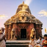 Jagannath Temple Puri at sunrise with devotees outside.