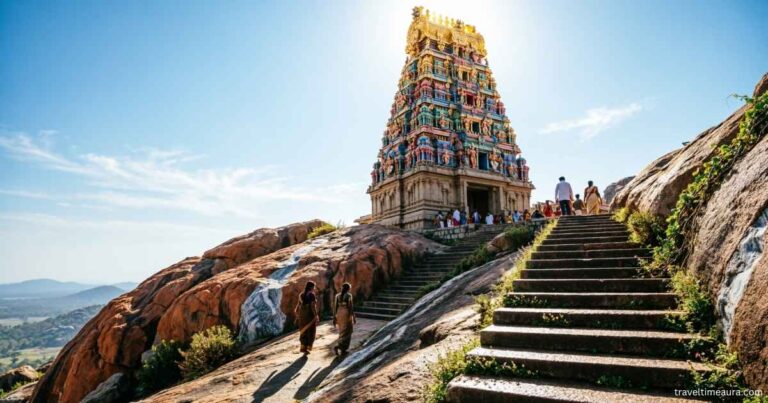 Hilltop Palani Murugan Temple with golden gopuram and steps leading up the rocky hill.