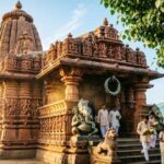 Dharmasthala Manjunatha Temple exterior with traditional architecture and devotees.