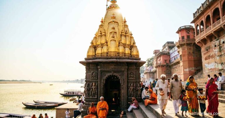 Golden-spired Kashi Vishwanath Temple in Varanasi with pilgrims around the entrance.